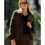 a woman wearing sunglasses and a brown jacket