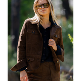 a woman wearing sunglasses and a brown jacket
