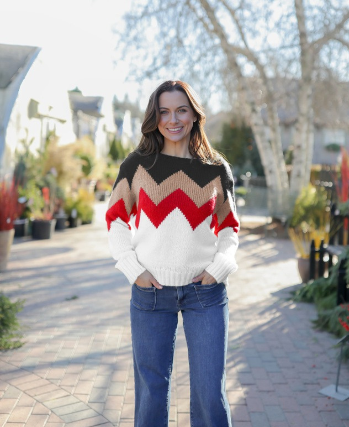 a woman standing on a brick path