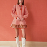 a woman in a dress and white boots