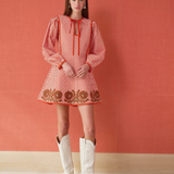 a woman in a dress and white boots