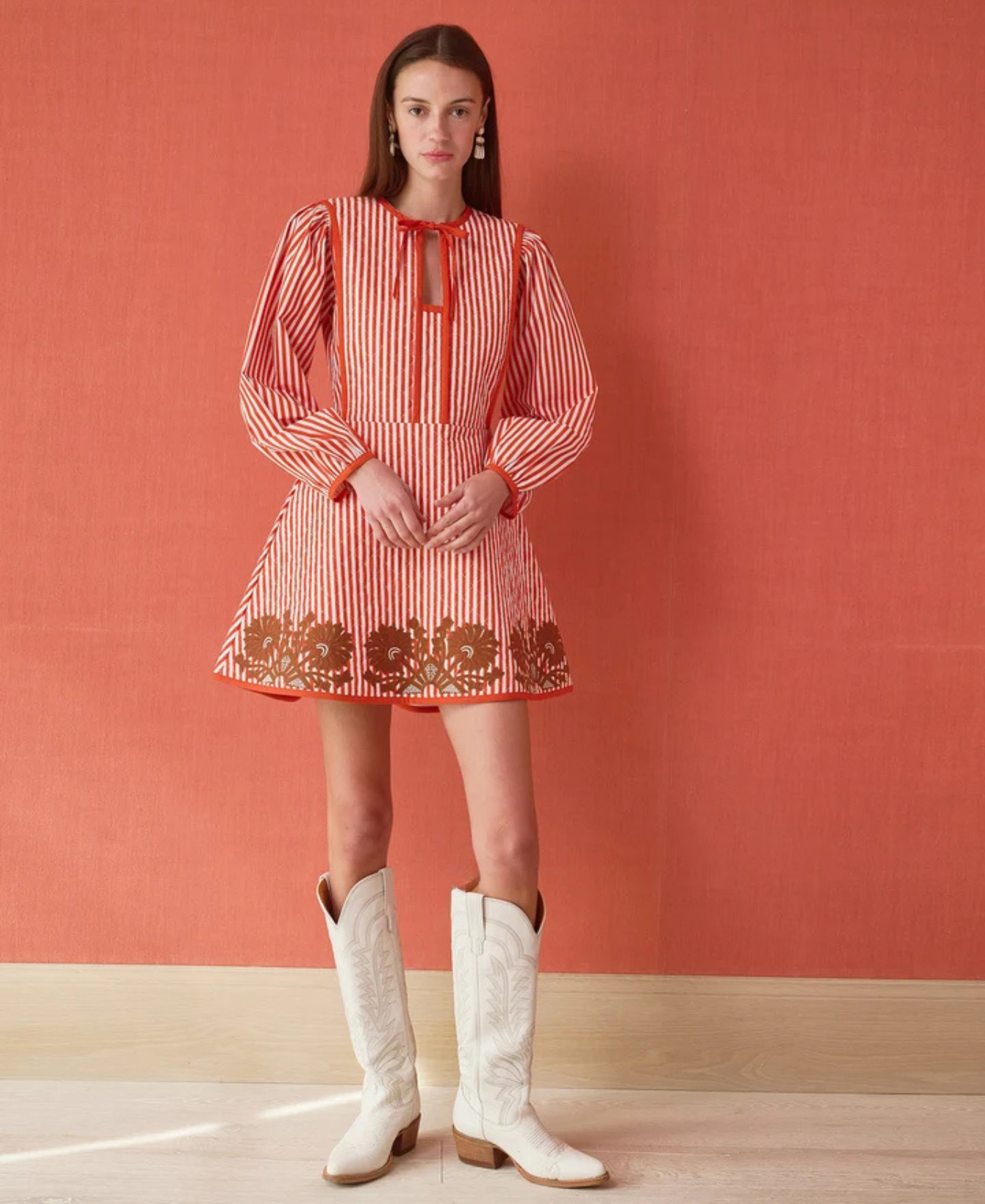 a woman in a dress and white boots
