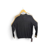 a black sweater with gold stripes on a swinger
