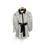 a white and black dress with a black belt