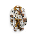 a white and brown floral shirt