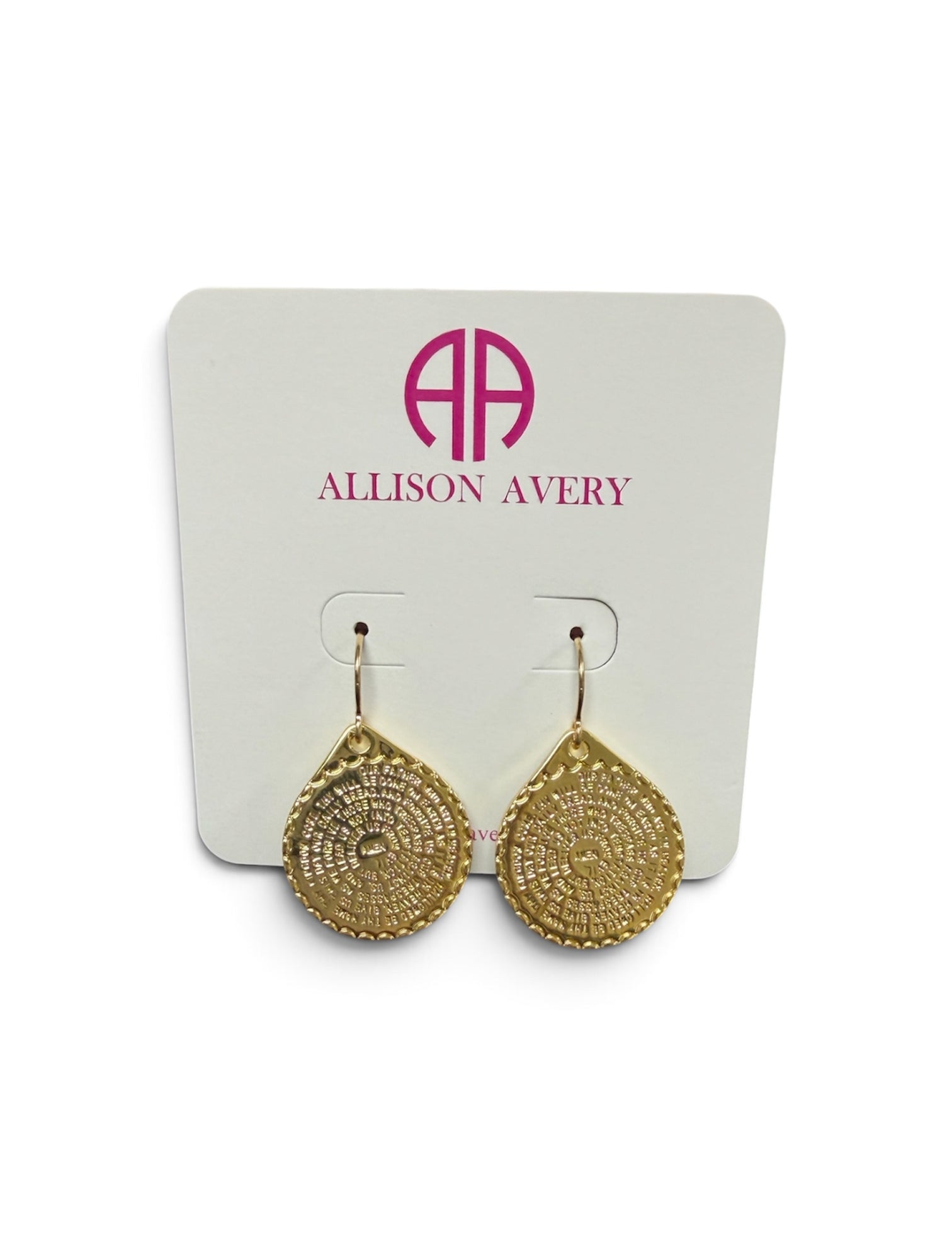 a pair of gold earrings on a white card