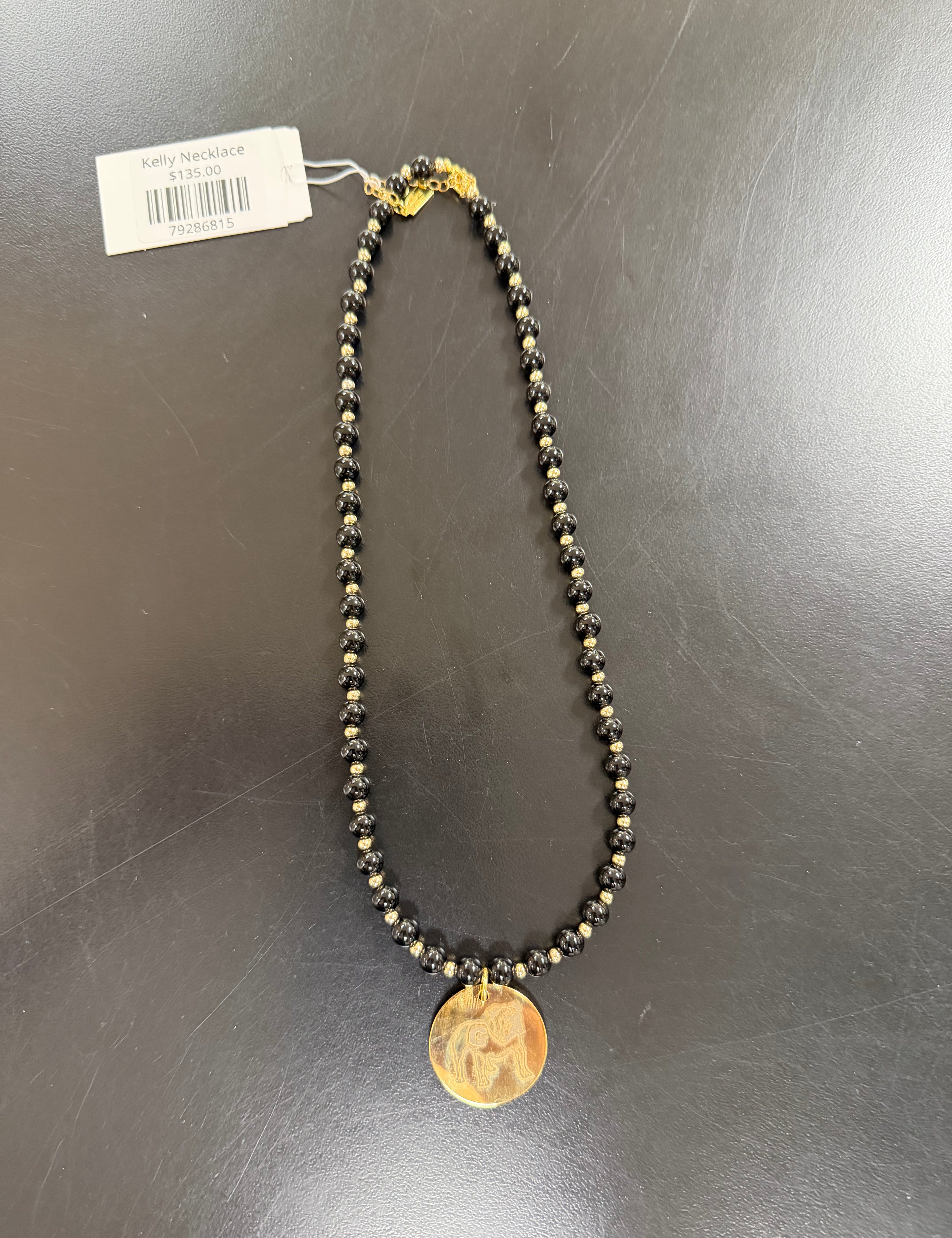 a necklace with a coin and a tag