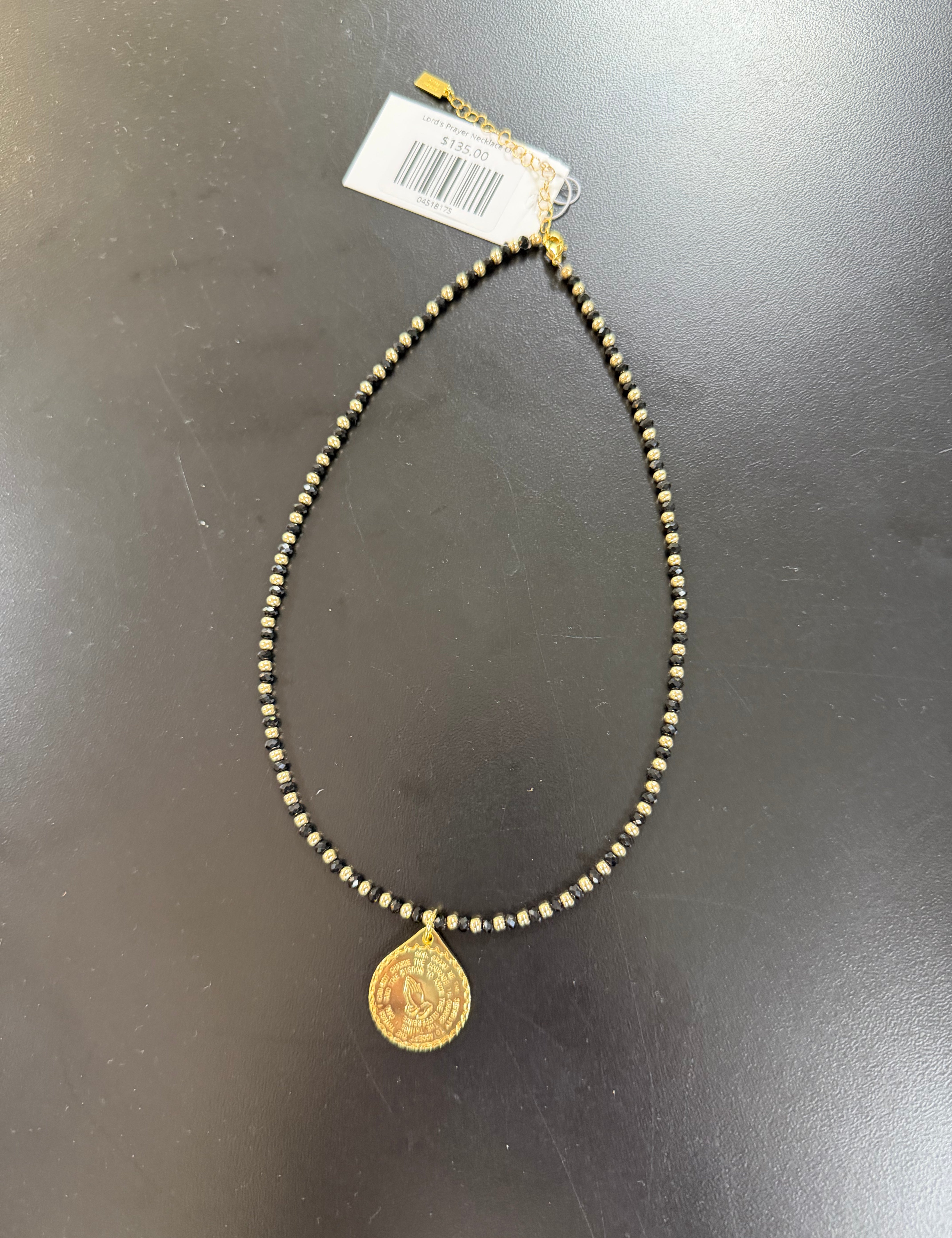 a gold necklace with a coin on it