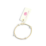 a gold bracelet with pearls on it