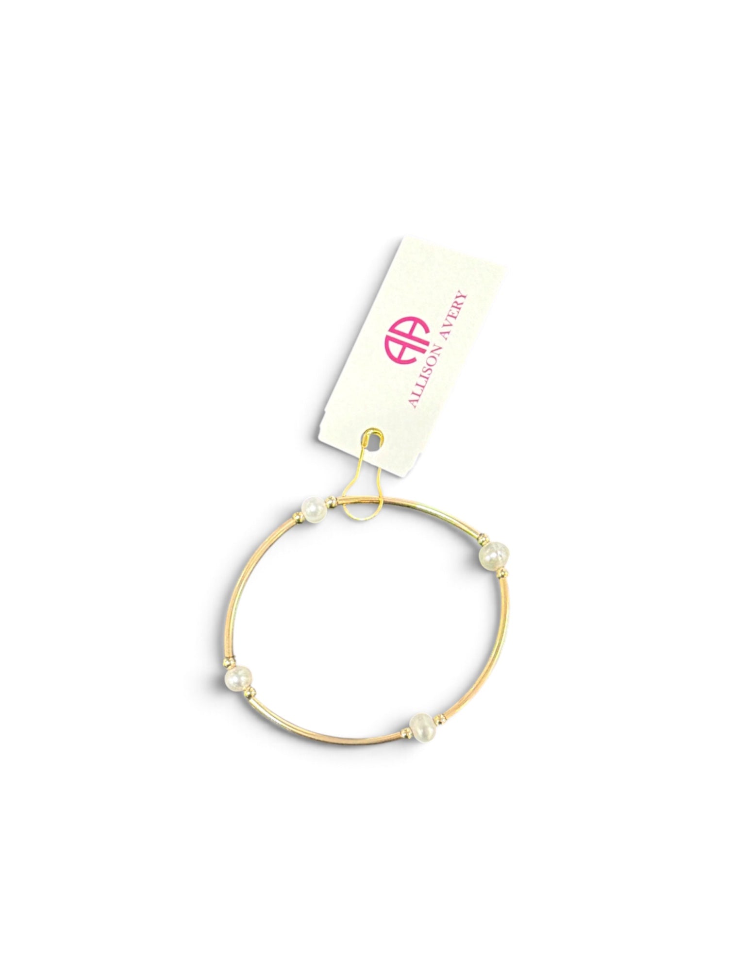 a gold bracelet with pearls on it