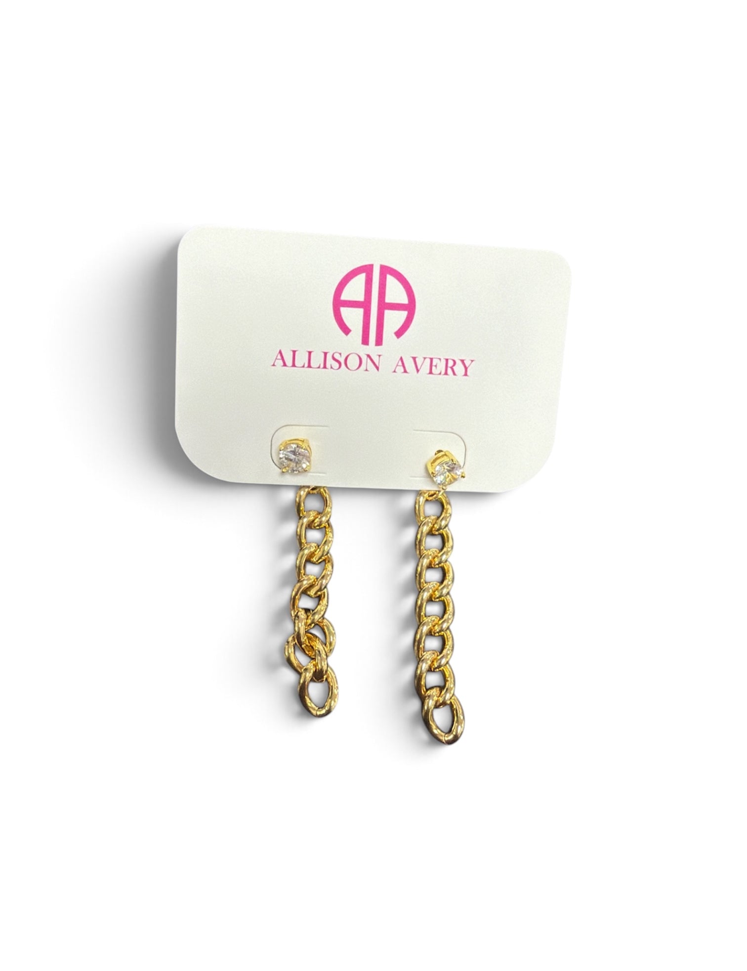 a white card with gold chain earrings