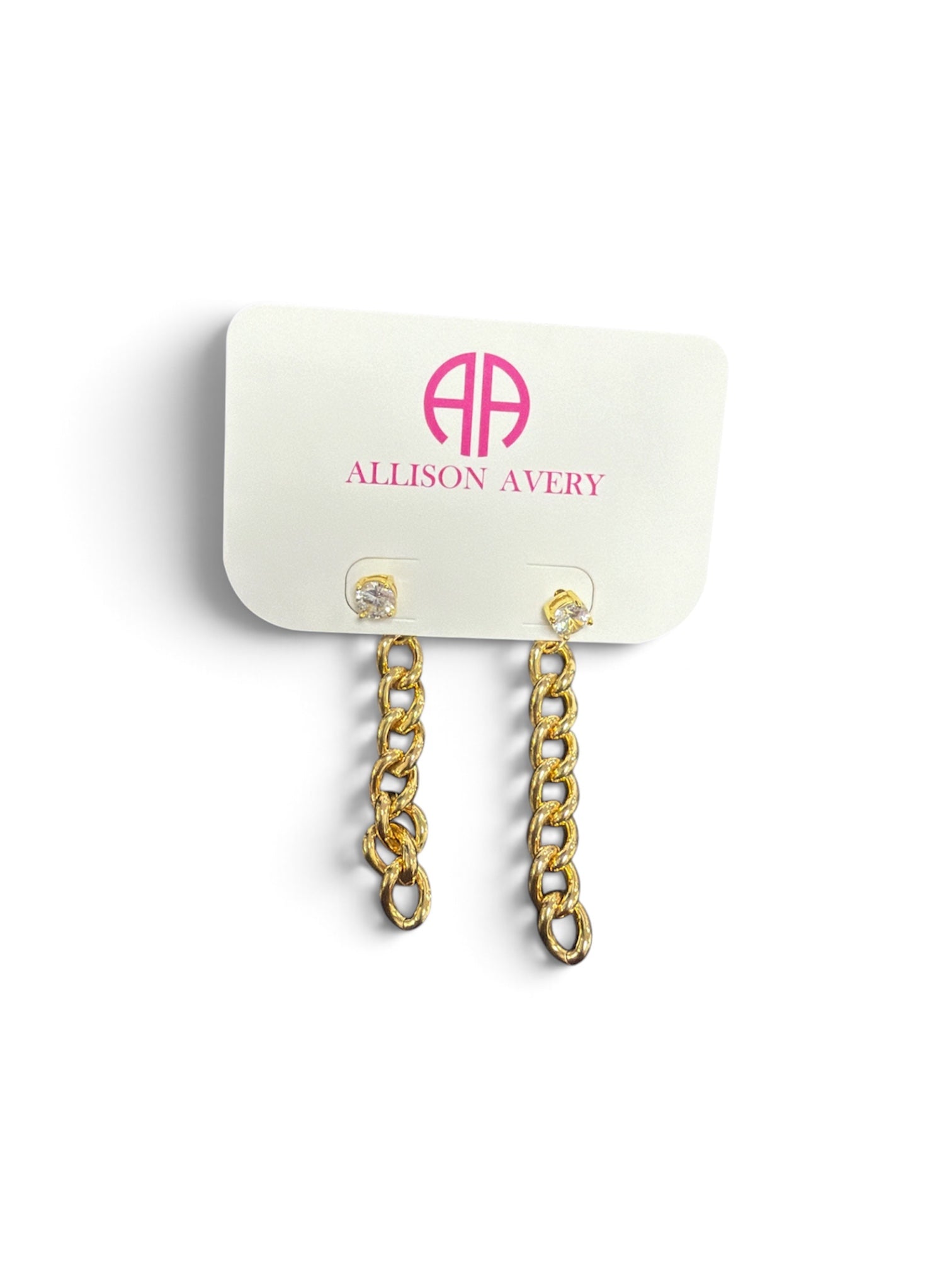 a white card with gold chain earrings
