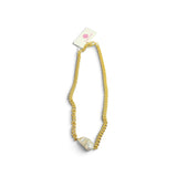 a gold chain with a pearl on it