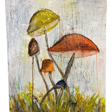 a painting of mushrooms on a piece of wood