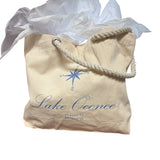 a bag with a rope handle and a white tissue paper