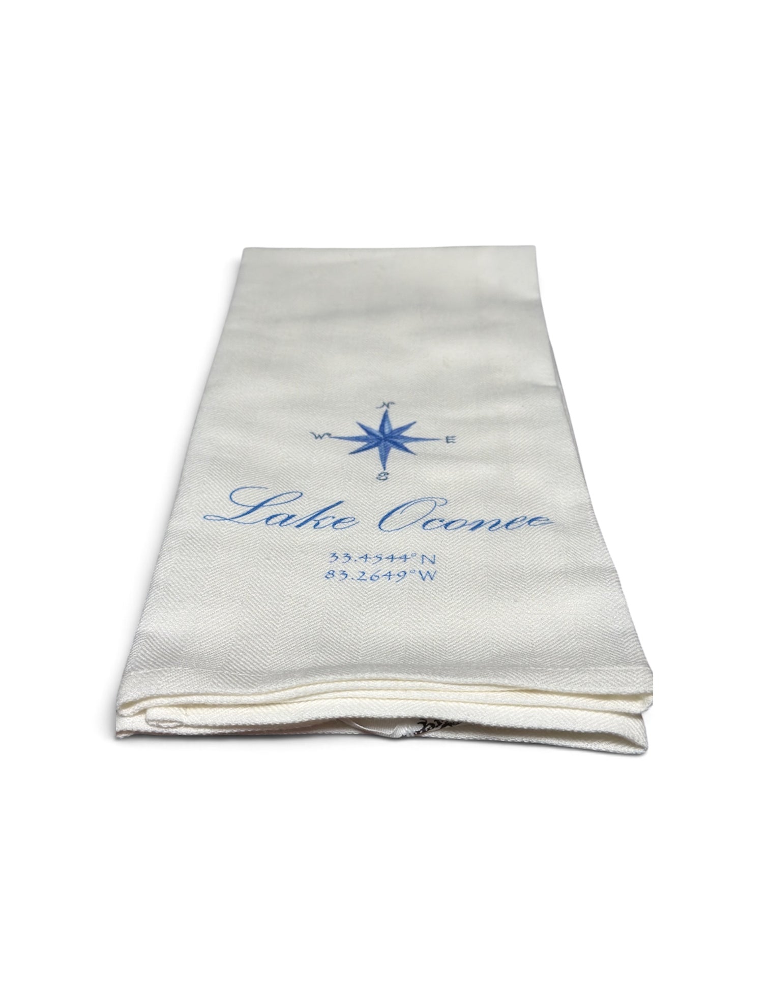 a folded white towel with blue text