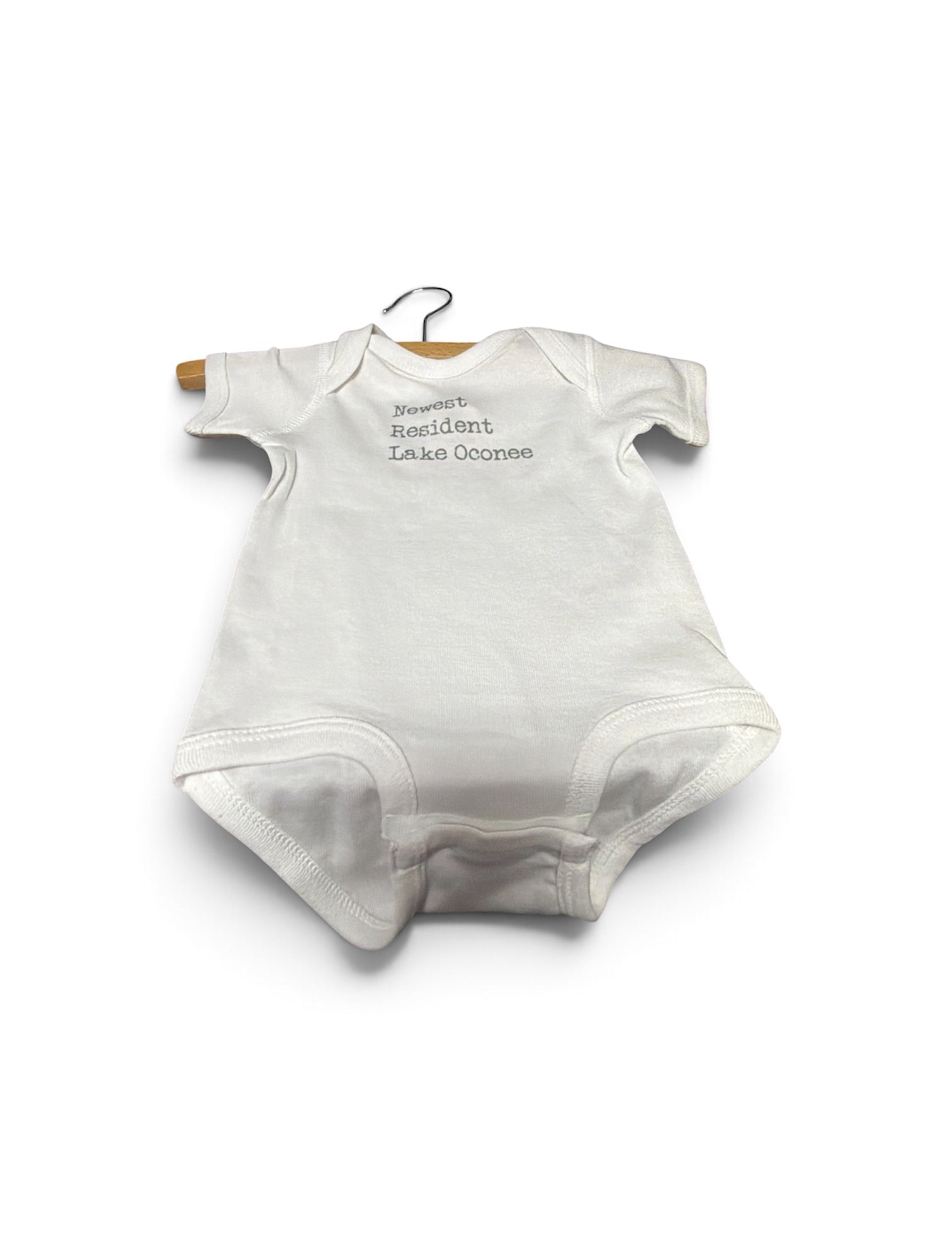 a white baby bodysuit on a swinger