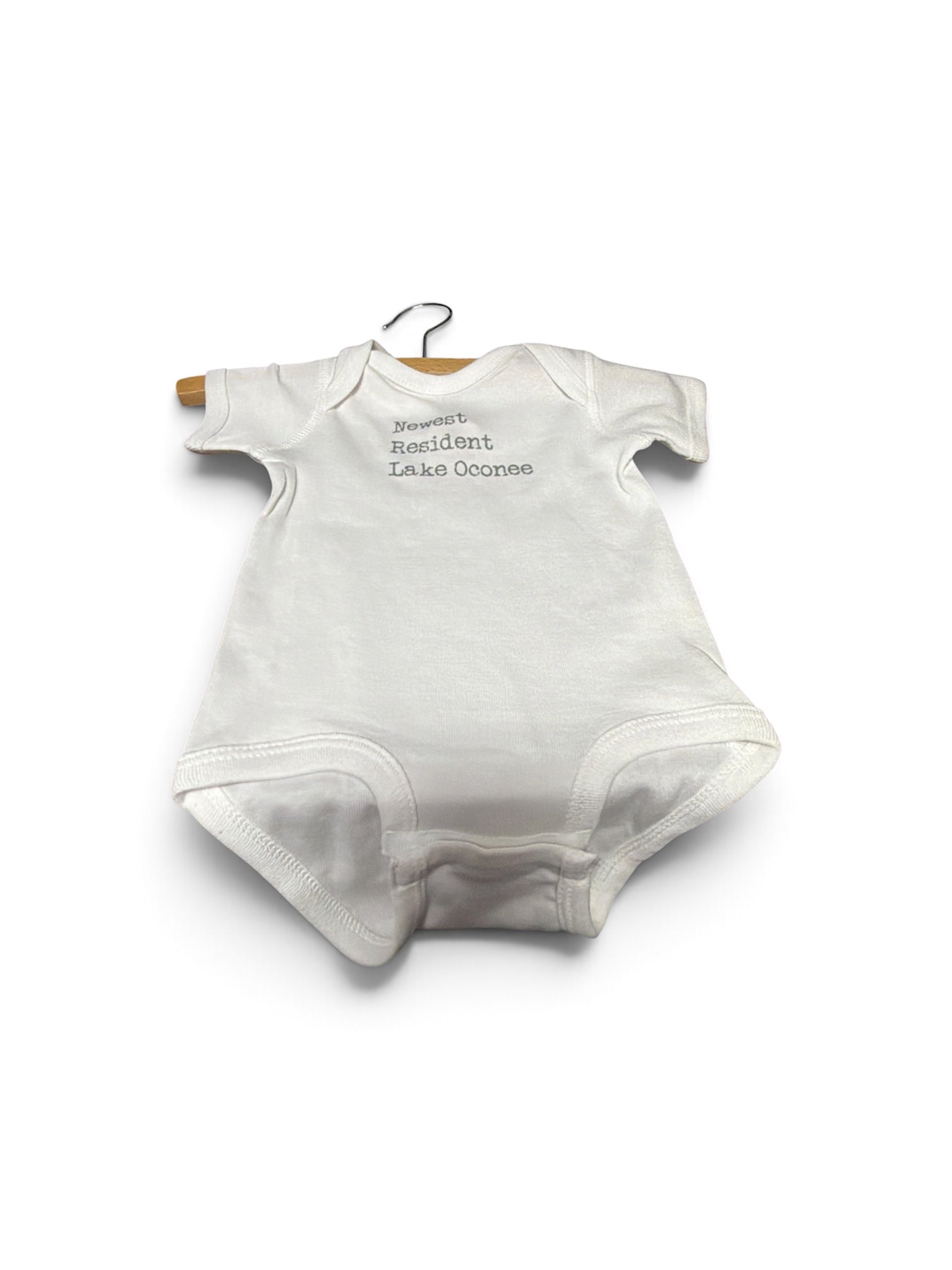 a white baby bodysuit on a swinger