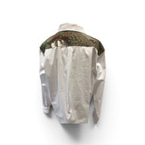 a white shirt with a green and brown design