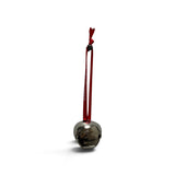 a silver bell with a red string