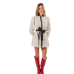 a woman in a white dress with red boots