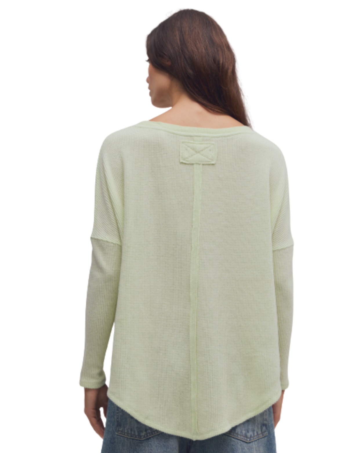 a woman wearing a green sweater