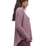 a woman in a purple sweater