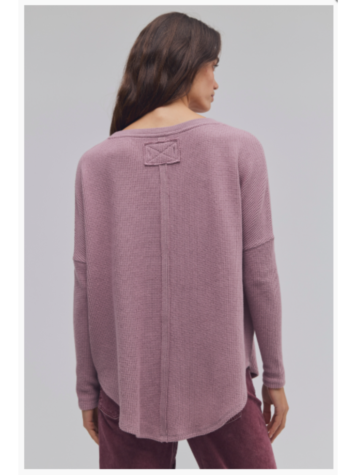 a woman wearing a pink sweater