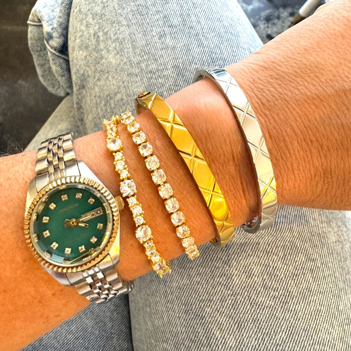 a wrist with many bracelets