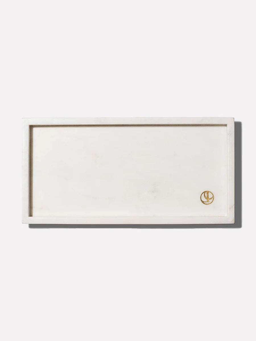 a rectangular white rectangular object with a gold logo