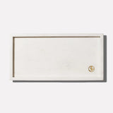 a rectangular white rectangular object with a gold logo