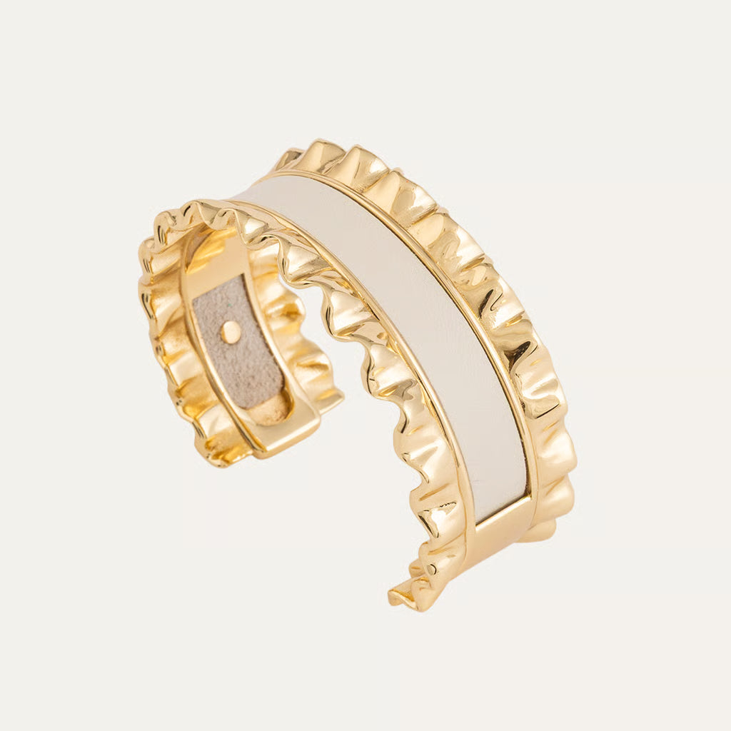 a gold and white bracelet