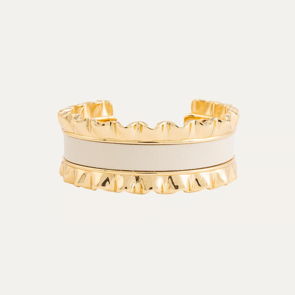 a gold and white bracelet