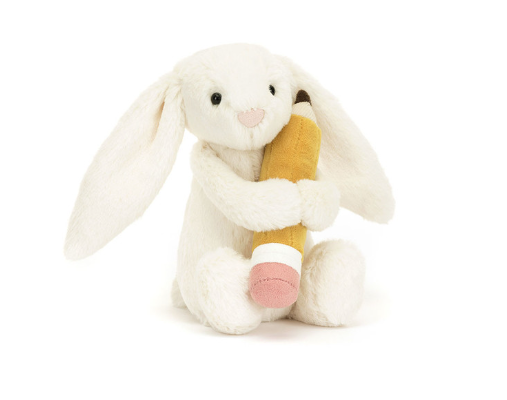 a stuffed animal holding a pencil