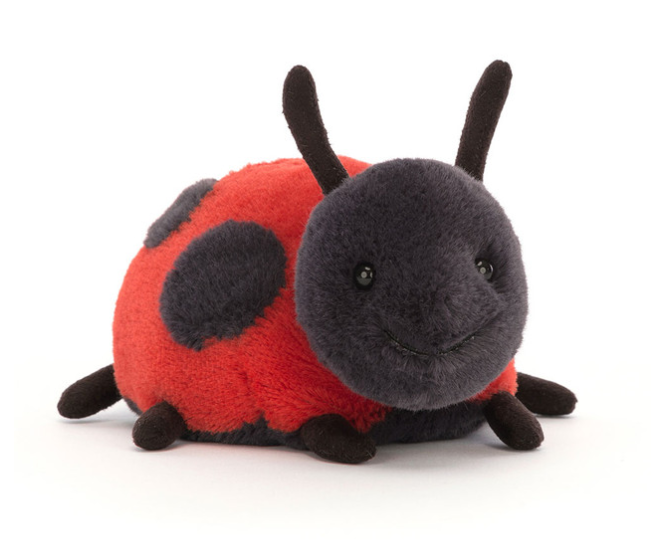 a stuffed ladybug toy on a white background