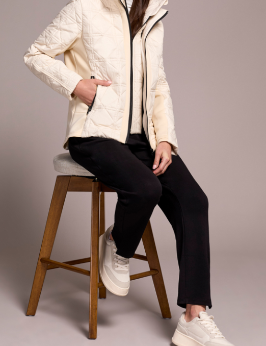 a woman sitting on a stool