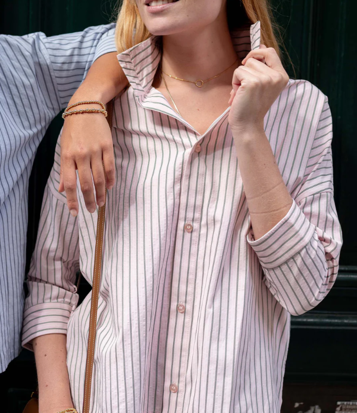 a woman holding a collared shirt