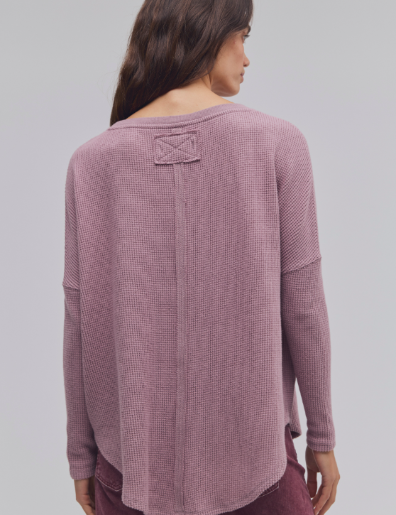 a woman wearing a pink sweater