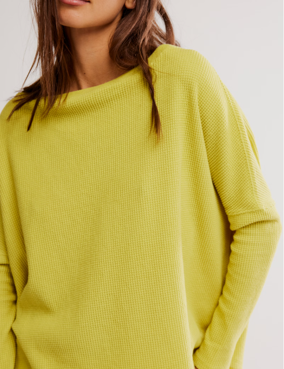 a woman wearing a yellow sweater