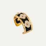a gold and black bracelet with flowers