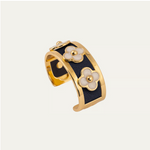 a gold and black cuff with flowers