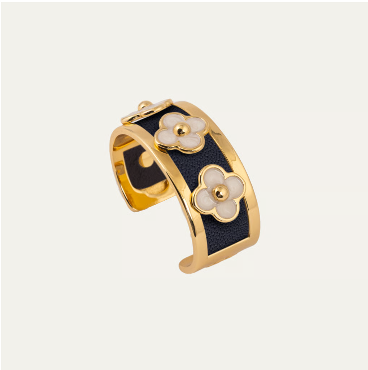 a gold and black cuff with flowers