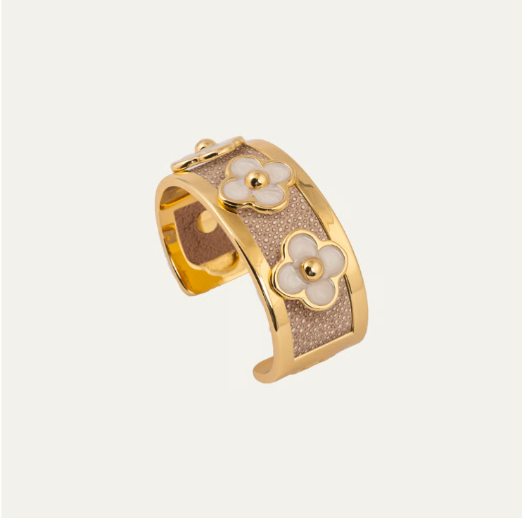 a gold and silver bracelet with flowers