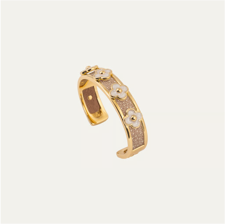 a gold and silver bracelet with flowers