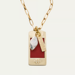 a gold chain with a red rectangular pendant and a pearl necklace