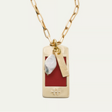 a gold chain with a red rectangular pendant and a pearl necklace
