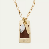 a gold chain with a pendant and a pearl necklace