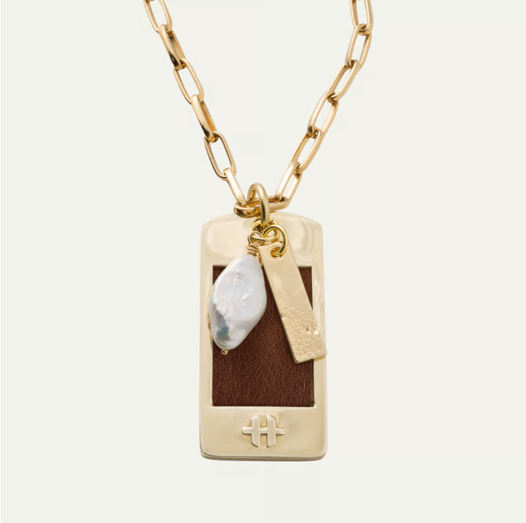 a gold chain with a pendant and a pearl necklace