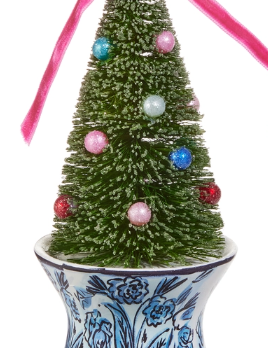 a small christmas tree in a blue and white pot