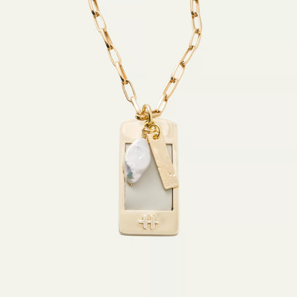 a necklace with a tag and a gold chain
